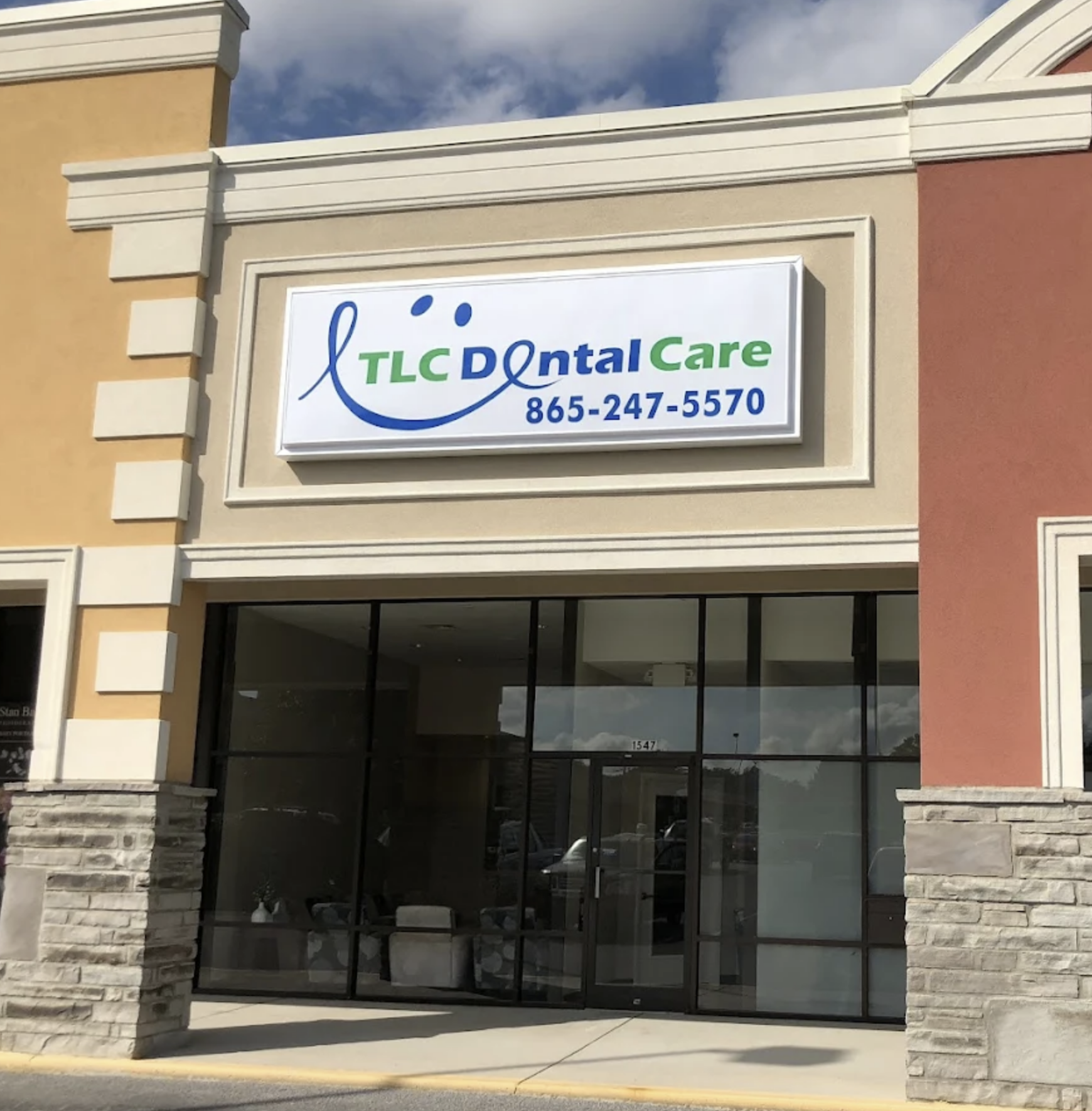 Exterior of TLC Dental Care in Knoxville, TN with office sign and entrance
